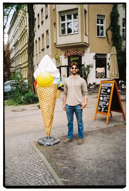 Standing next to a giant ice cream cone outside a café