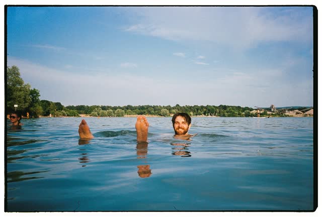 Floating on my back in a lake, feet sticking out of the water